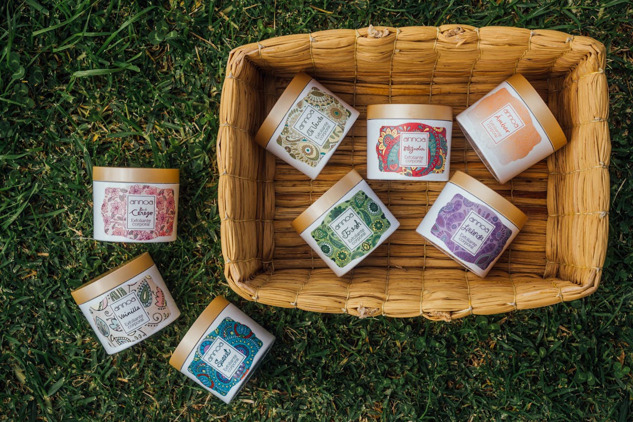 Seven vibrant herbal containers arranged in a bamboo basket on green grass, showcasing unique designs and natural themes.